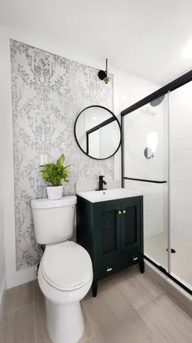 a bathroom with a toilet sink and mirror