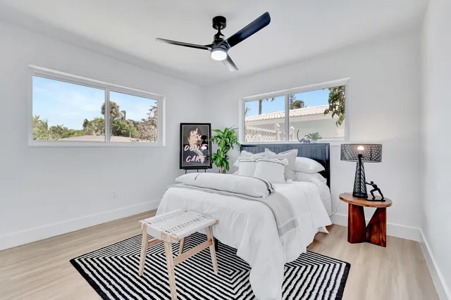 a bedroom with a bed and a painting on the wall