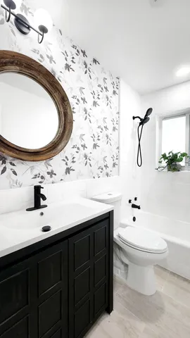 a bathroom with a sink toilet and mirror