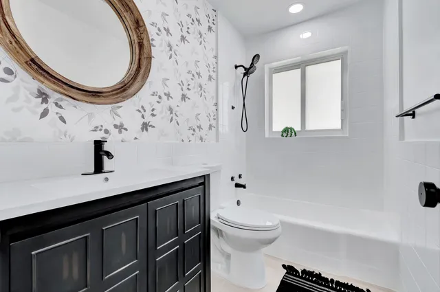 a bathroom with a sink a toilet and a mirror