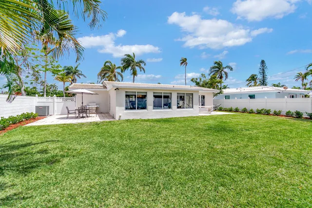 a view of a house with a swimming pool and a yard