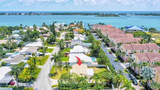 an aerial view of lake and residential houses with outdoor space
