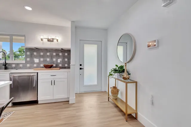 a living room with a mirror and a table
