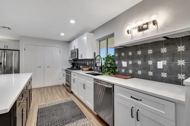 a kitchen with a sink and refrigerator