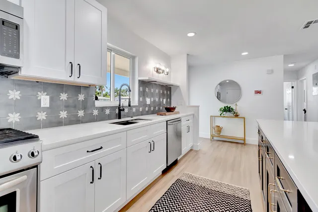 a kitchen with cabinets a sink and a stove