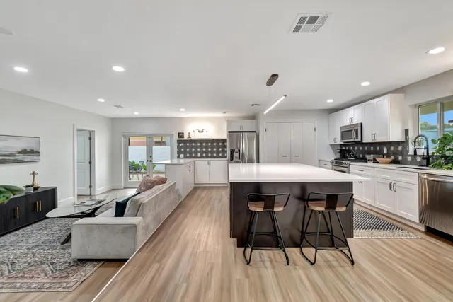 a large kitchen with a table and chairs