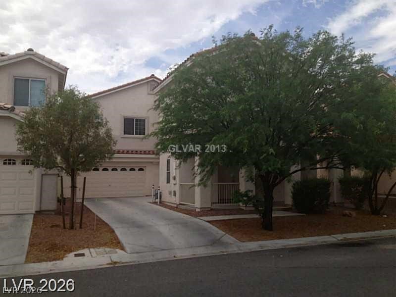 8897 Houston Ridge Avenue Las Vegas, NV 89178 - Photo 1 of 12 A well-maintained facade with mature trees and ample driveway space.