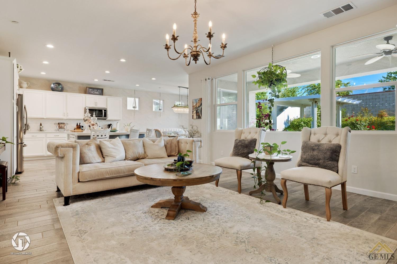 Undisclosed Address Bakersfield, CA 93311 - Photo 12 of 49 a living room with furniture and a chandelier