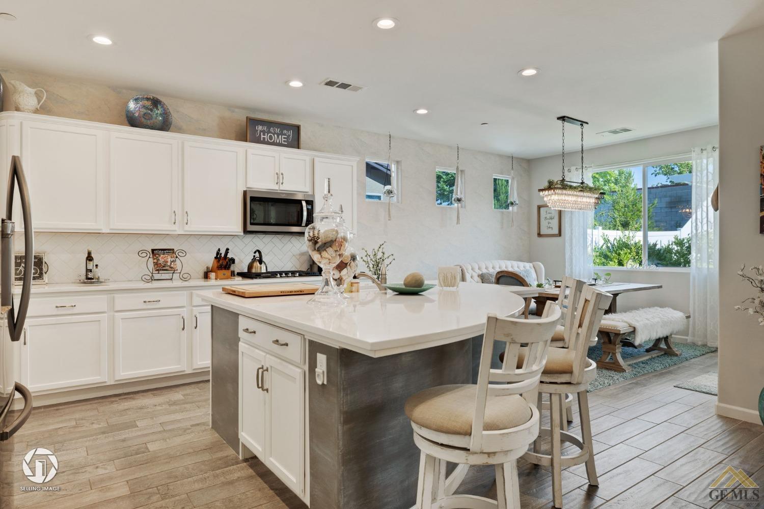 Undisclosed Address Bakersfield, CA 93311 - Photo 17 of 49 a kitchen with a sink cabinets and wooden floor