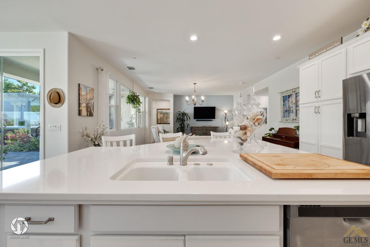 Undisclosed Address Bakersfield, CA 93311 - Photo 19 of 49 a kitchen with stainless steel appliances kitchen island granite countertop a sink and cabinets