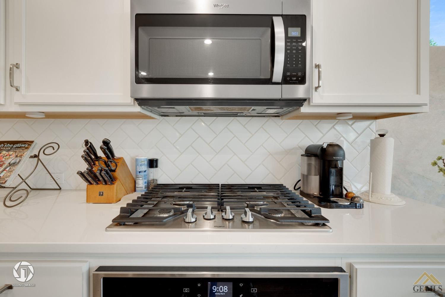 Undisclosed Address Bakersfield, CA 93311 - Photo 21 of 49 a stove top oven sitting inside of a kitchen