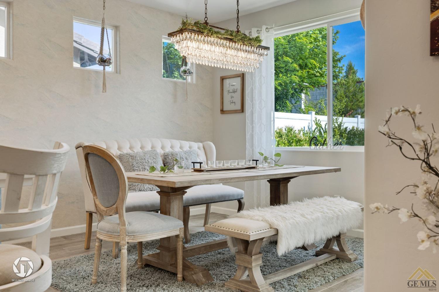 Undisclosed Address Bakersfield, CA 93311 - Photo 23 of 49 a dining room with furniture a rug and a chandelier