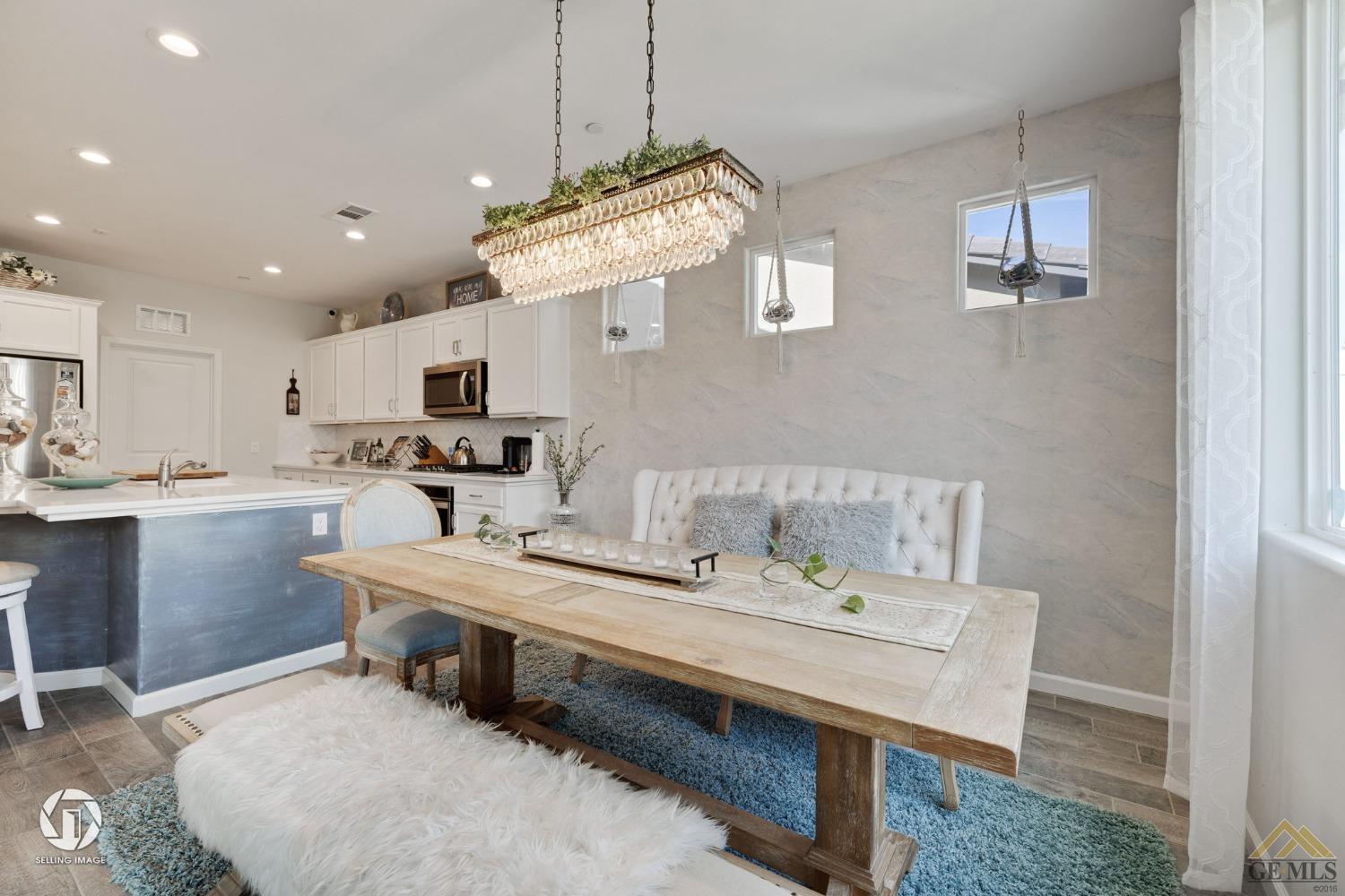 Undisclosed Address Bakersfield, CA 93311 - Photo 25 of 49 a room with stainless steel appliances kitchen island granite countertop a sink a stove a dining table and chairs