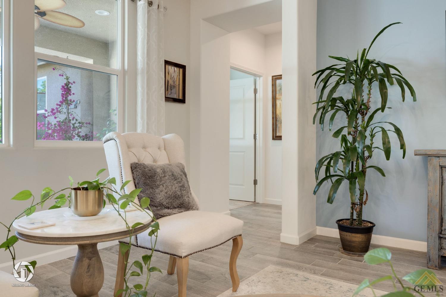 Undisclosed Address Bakersfield, CA 93311 - Photo 26 of 49 a living room with furniture potted plant and a glass door