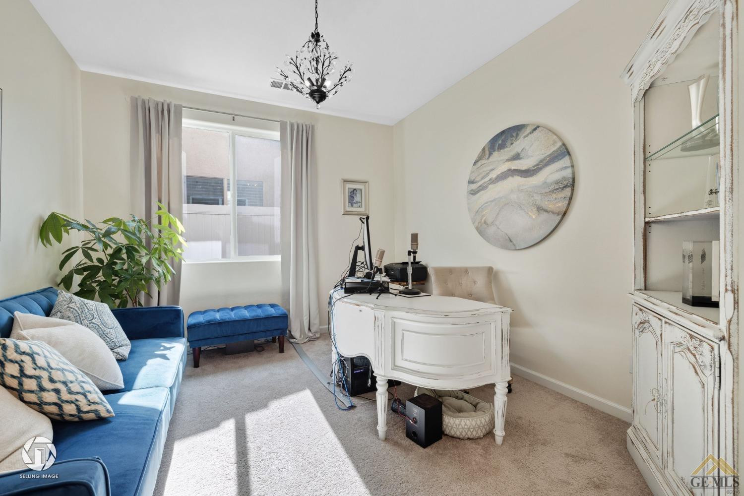 Undisclosed Address Bakersfield, CA 93311 - Photo 34 of 49 a living room with furniture a chandelier a mirror and a window