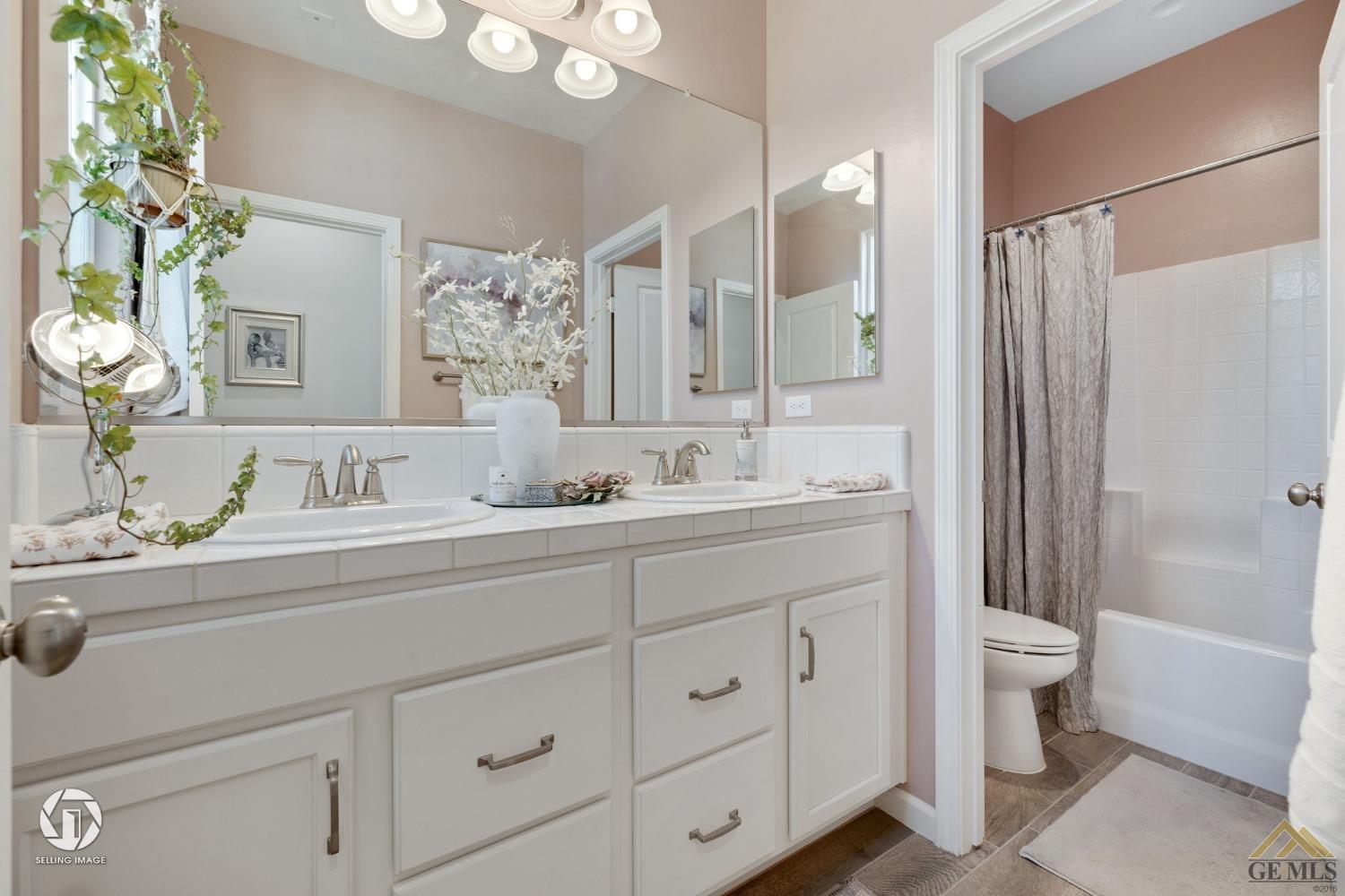 Undisclosed Address Bakersfield, CA 93311 - Photo 37 of 49 a bathroom with a double vanity sink mirror double and shower