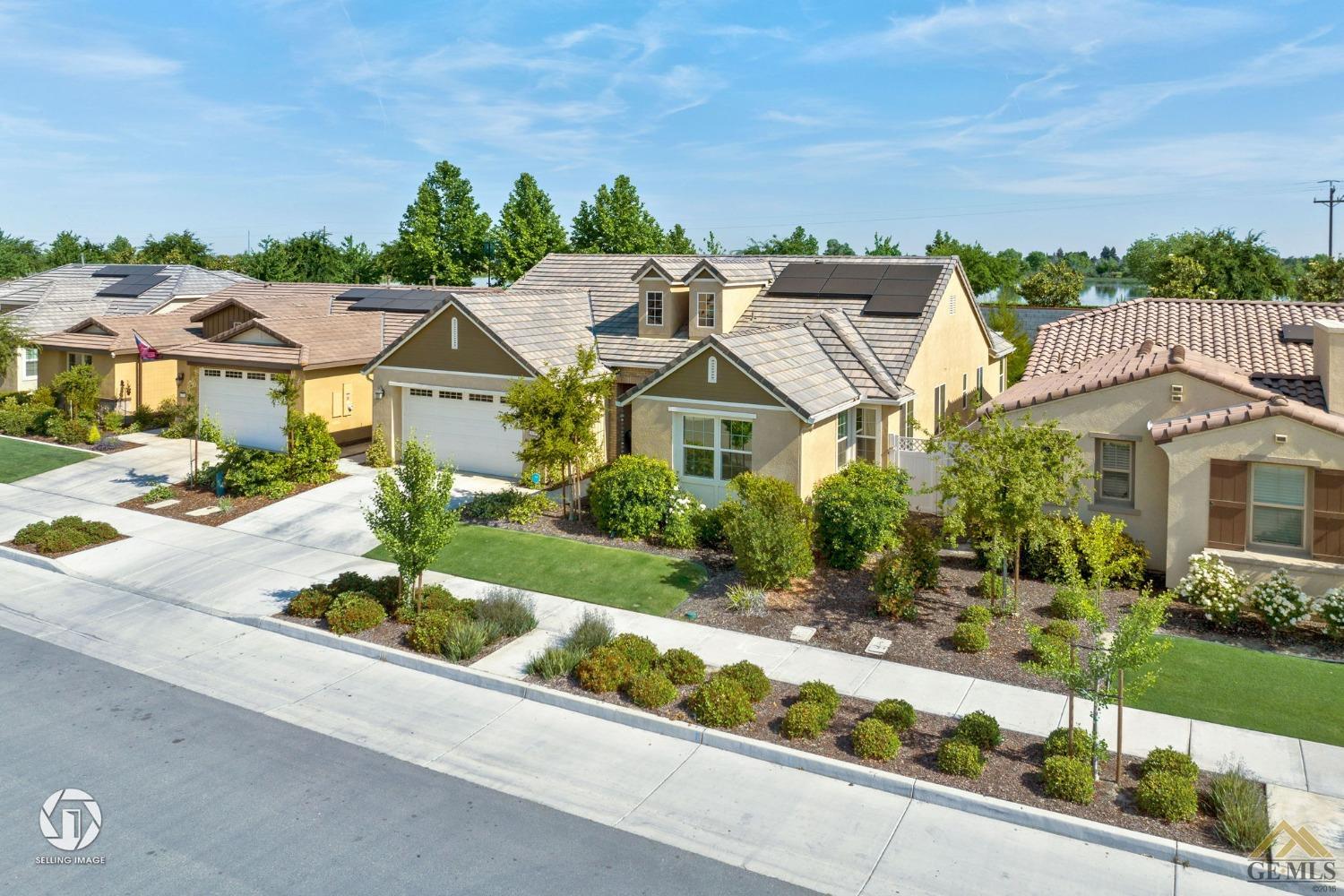 Undisclosed Address Bakersfield, CA 93311 - Photo 4 of 49 a view of a white house next to a yard and a road