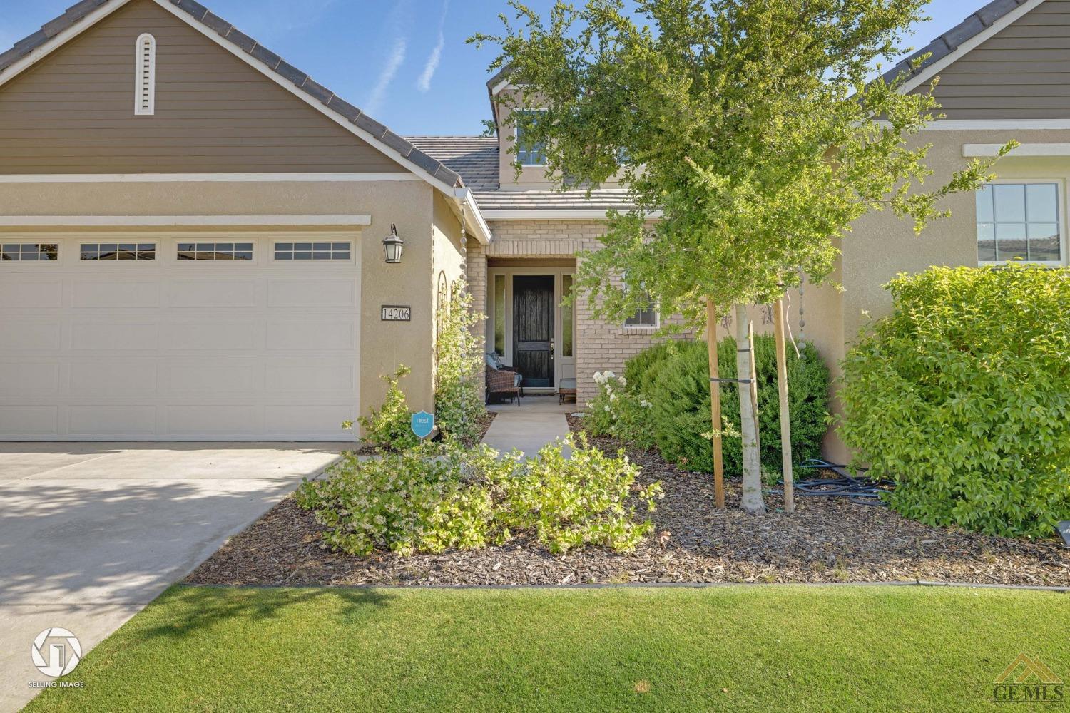 Undisclosed Address Bakersfield, CA 93311 - Photo 8 of 49 a front view of a house with a yard