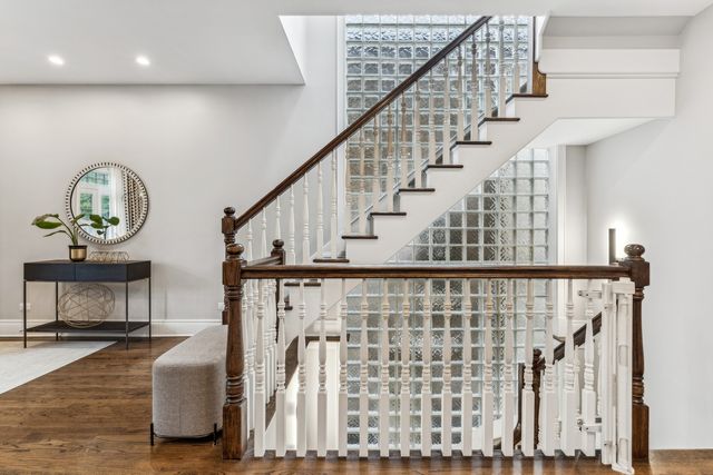 a view of staircase with wooden floor and a potted plant
