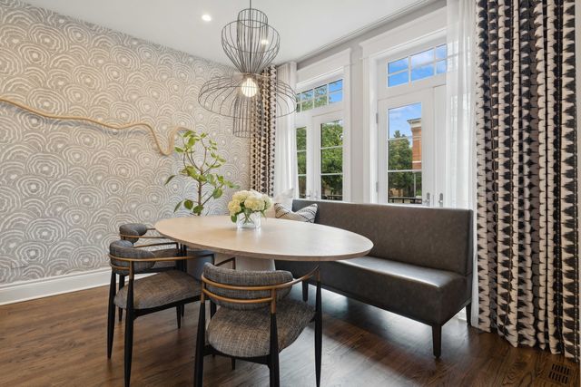 a view of a dining room with furniture wooden floor and chandelier