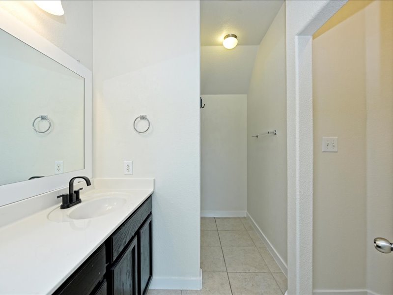 2101 Rivers Edge Way, Unit 29 Austin, TX 78741 - Photo 18 of 34 a bathroom with a sink and mirror