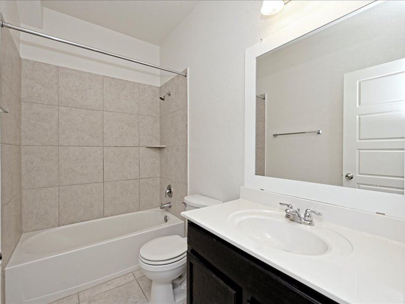 2101 Rivers Edge Way, Unit 29 Austin, TX 78741 - Photo 26 of 34 a bathroom with a sink a toilet and shower
