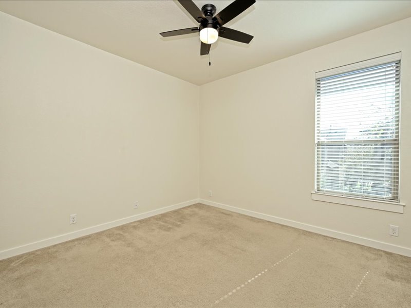 2101 Rivers Edge Way, Unit 29 Austin, TX 78741 - Photo 27 of 34 an empty room with a window and a fan