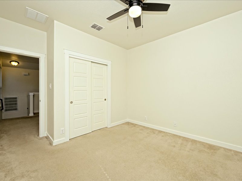 2101 Rivers Edge Way, Unit 29 Austin, TX 78741 - Photo 28 of 34 an empty room with a chandelier fan and a chandelier fan