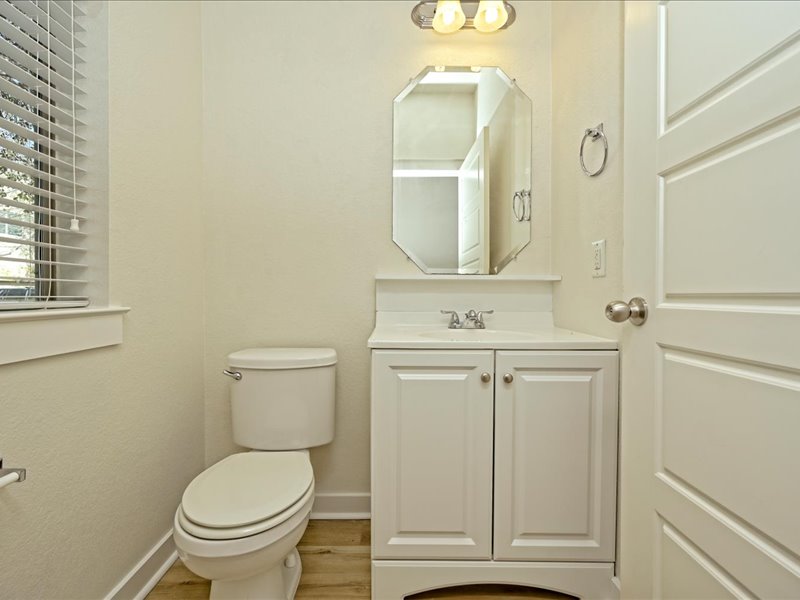 2101 Rivers Edge Way, Unit 29 Austin, TX 78741 - Photo 30 of 34 a bathroom with a toilet sink and mirror