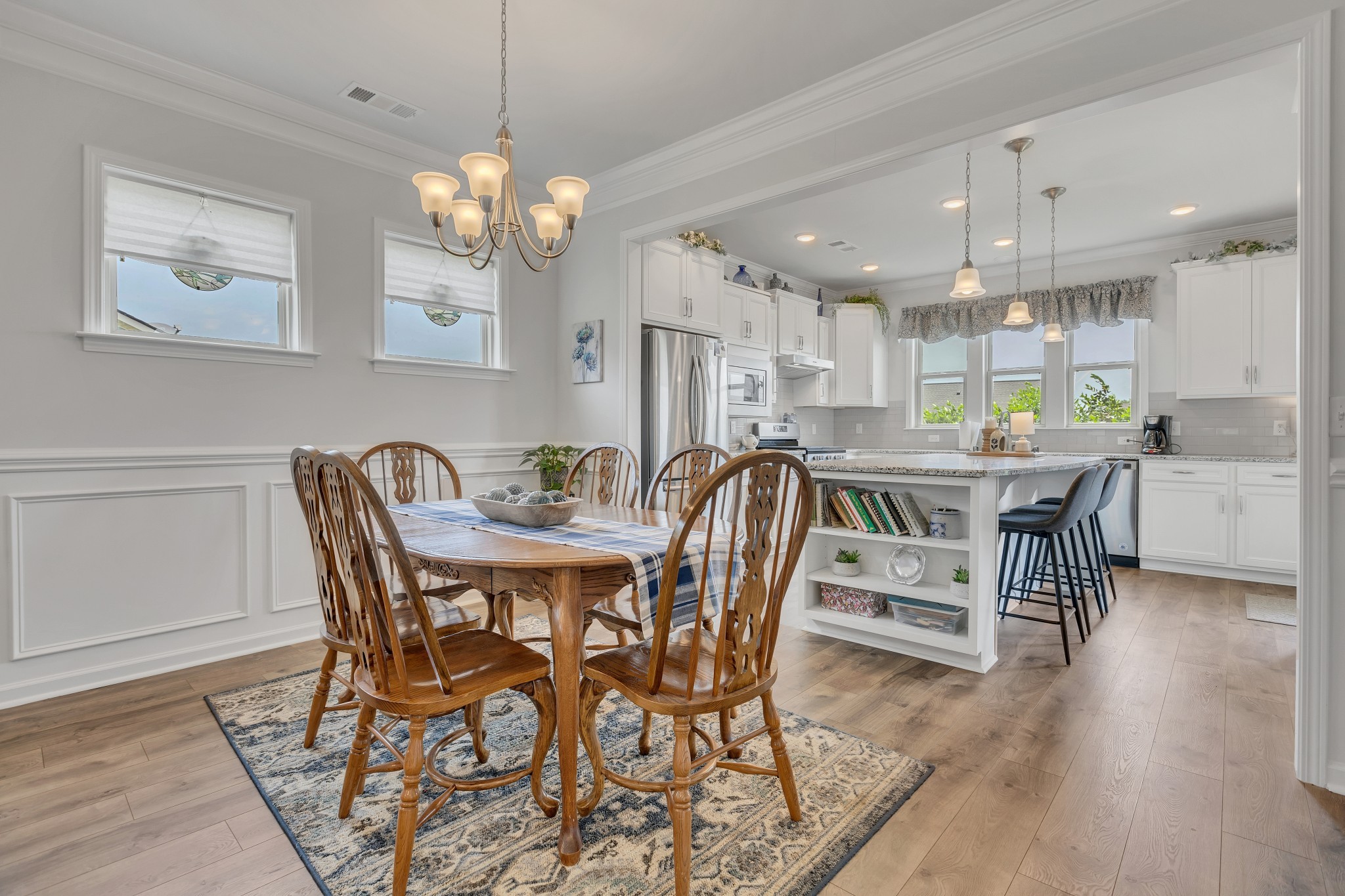 1514 Bledsoe Knoll Spring Hill, TN 37174 - Photo 12 of 47 a dining room filled chandelier and wooden floor
