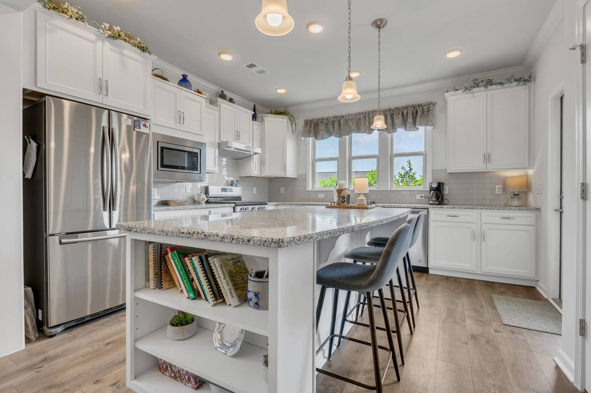 1514 Bledsoe Knoll Spring Hill, TN 37174 - Photo 14 of 47 a kitchen with stainless steel appliances granite countertop a refrigerator a sink dishwasher a stove and white cabinets with wooden floor