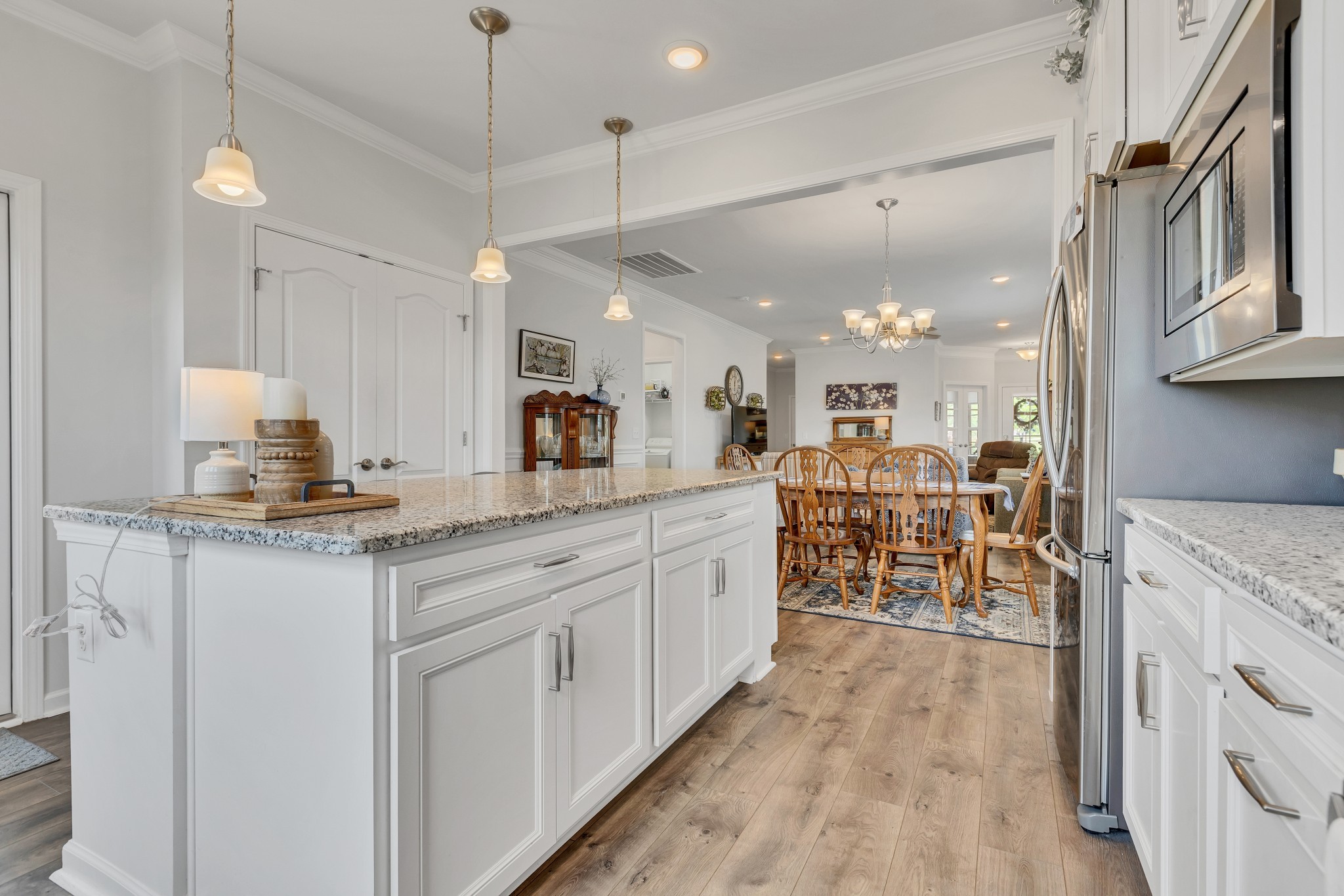 1514 Bledsoe Knoll Spring Hill, TN 37174 - Photo 16 of 47 a large kitchen with kitchen island a large island a sink appliances and a counter top space