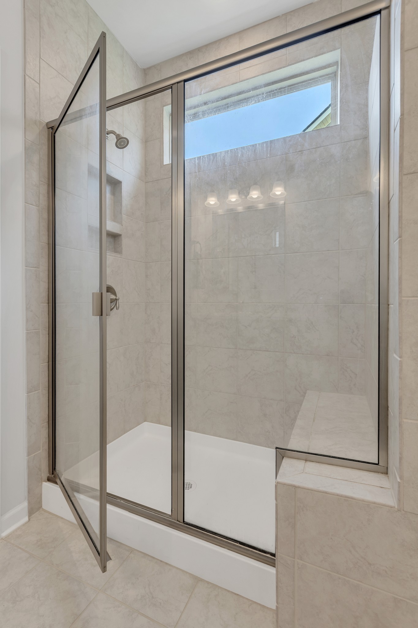 1514 Bledsoe Knoll Spring Hill, TN 37174 - Photo 20 of 47 a bathroom with a glass shower door