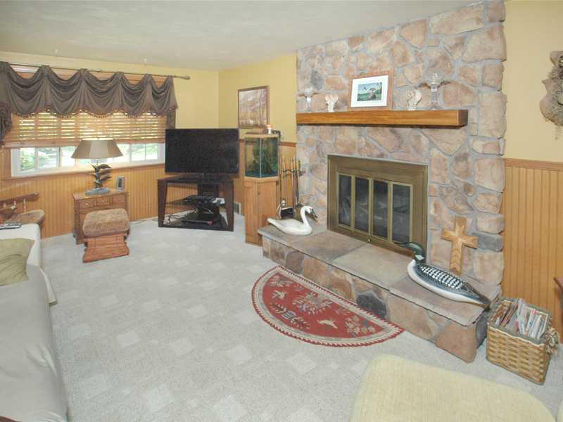 Family Room. BEAUTIFUL FLOOR TO CEILING STONE FIREPLACE! LARGE FAMILY ROOM WINDOWS. ANDERSON SLIDING GLASS  DOOR LEADS OUT TO SUNROOM