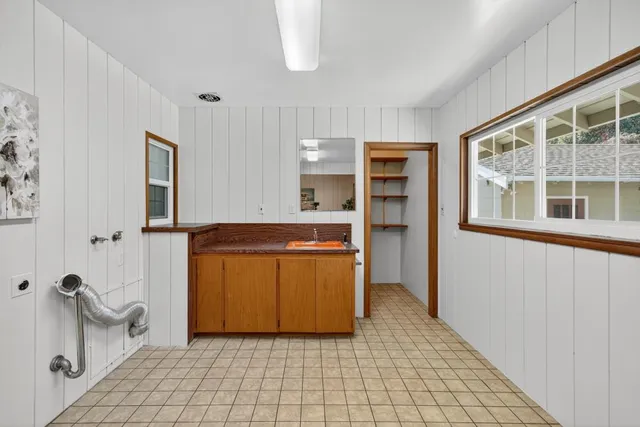 a view of a room with a table and chairs