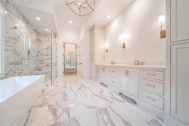 a bathroom with a bathtub sink and mirror