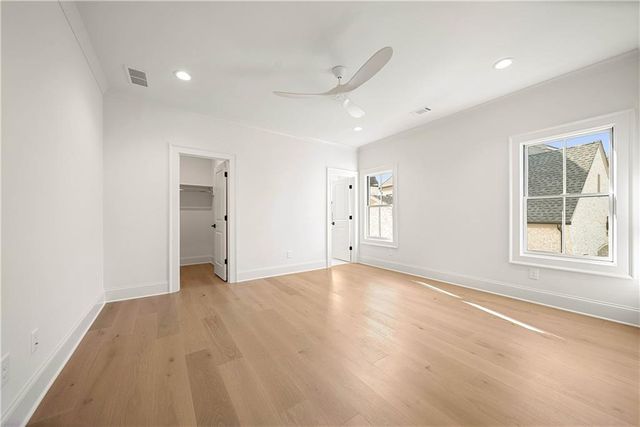 an empty room with windows and closet