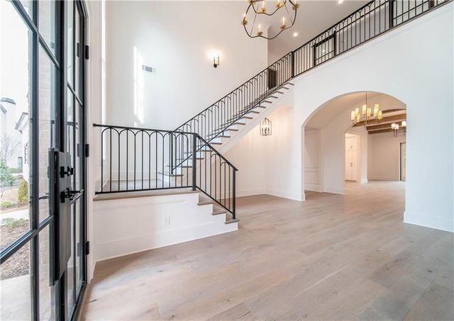 a view of staircase with lots of frames on wall and a window