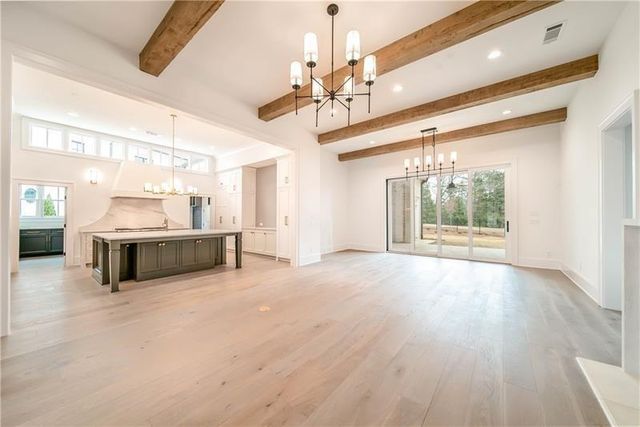 a large room with a large window and chandelier