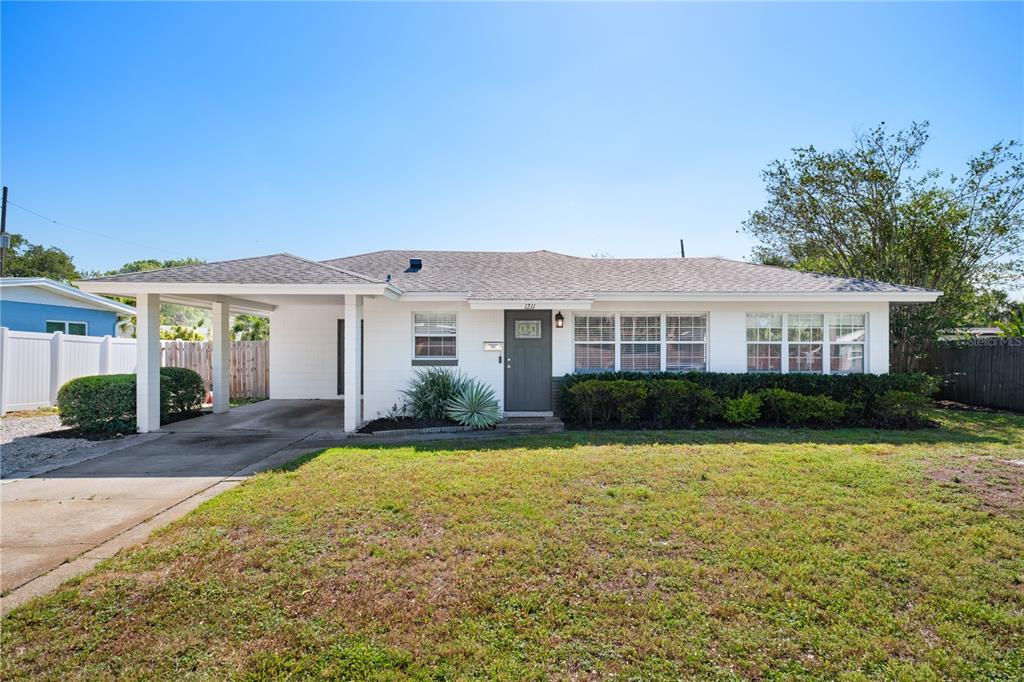 a front view of a house with yard and green space