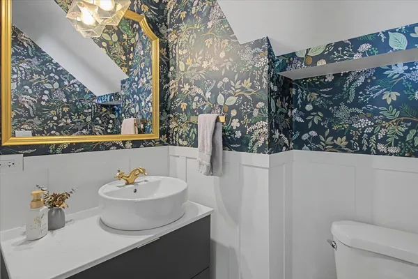 a bedroom with a bed and a flat tv screen on dresser