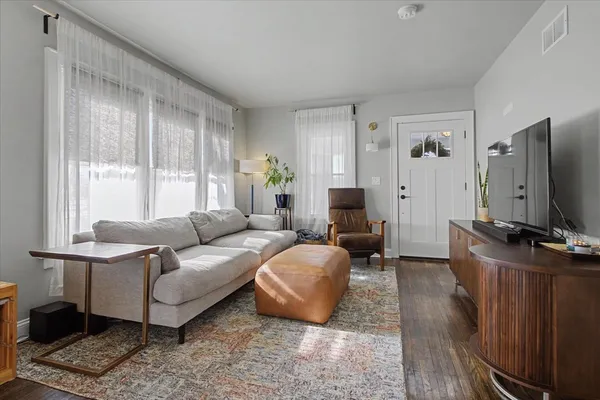 a living room with furniture and a large window