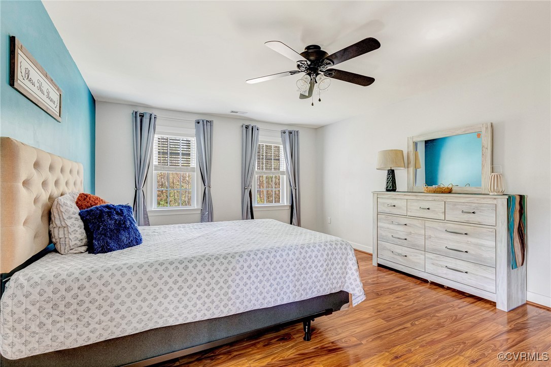 8773 Rock Cedar Road New Kent, VA 23124 - Photo 23 of 37 Primary Bedroom w/wood floors & a ceiling fan