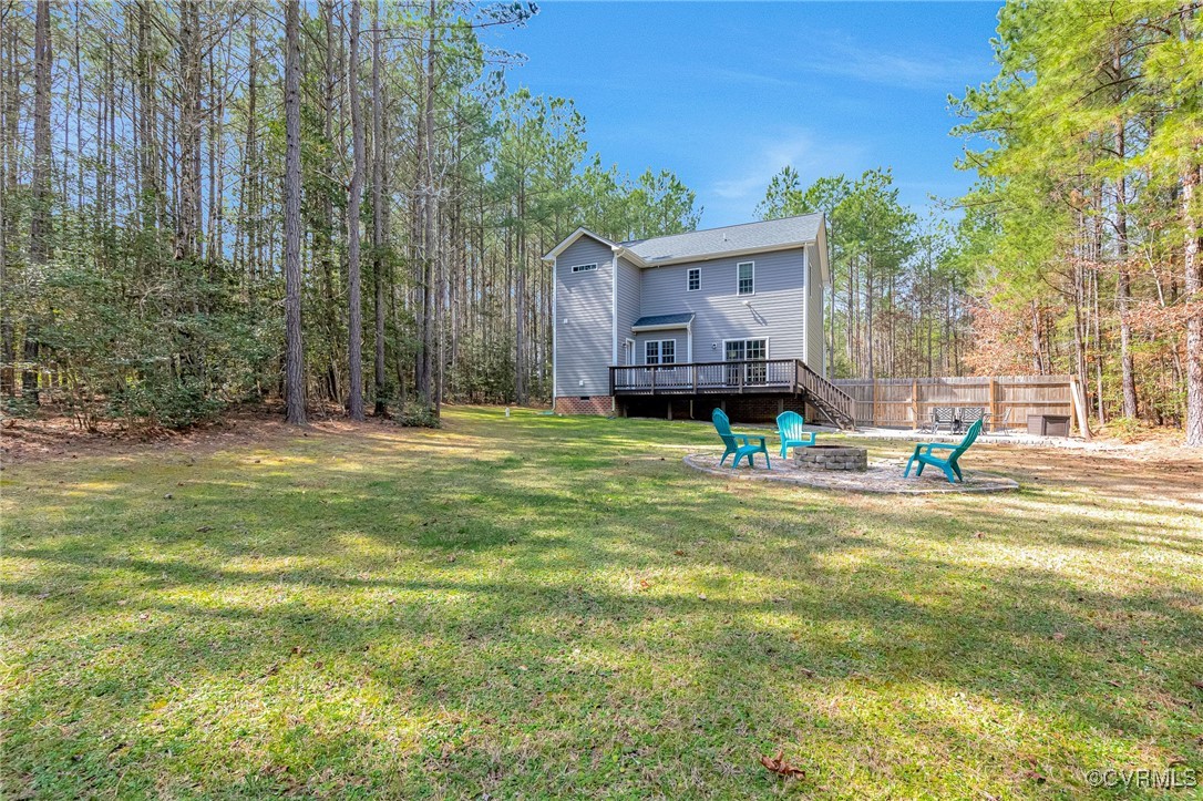 8773 Rock Cedar Road New Kent, VA 23124 - Photo 34 of 37 Back of house featuring fence, a fire pit, lawn &