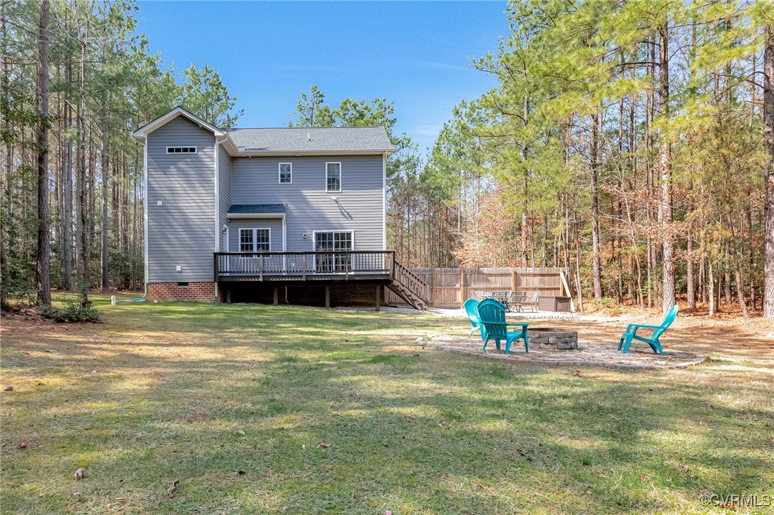 8773 Rock Cedar Road New Kent, VA 23124 - Photo 35 of 37 Rear view of property featuring fence, a fire pit,