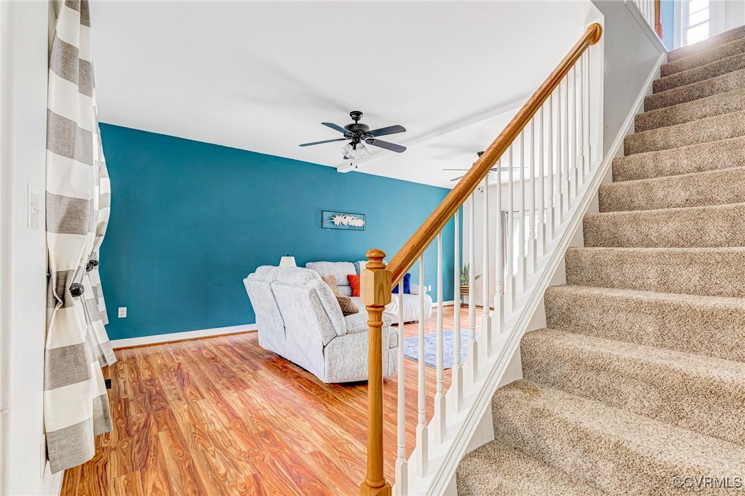 8773 Rock Cedar Road New Kent, VA 23124 - Photo 4 of 37 Staircase, Family Room w/ceiling fan, and wood fin