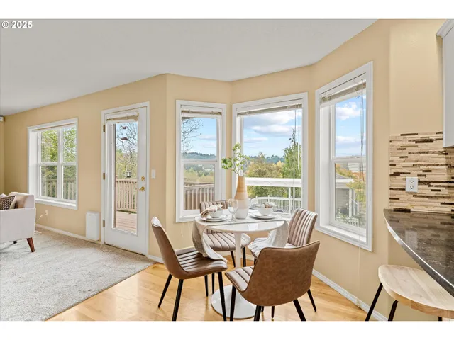 a dining room with furniture and large windows