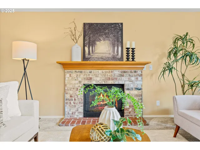 a living room with a couch a table and a potted plant
