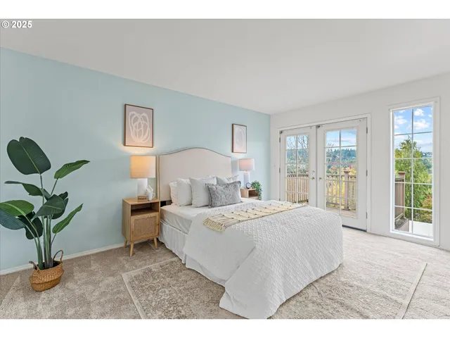 a bedroom with a large bed and a potted plant