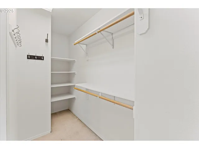 a view of walk in closet with empty racks